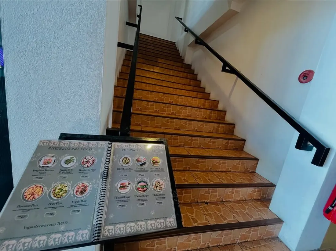 Stairway up to Govinda's with the menu on display